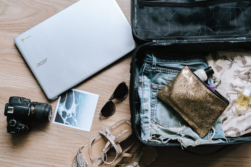 <luggage with laptop, camera, clothing and accessories>