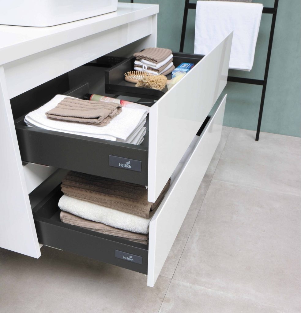 Two bathroom drawers are open showing the organisation of bathroom items after using a cleaning calendar.